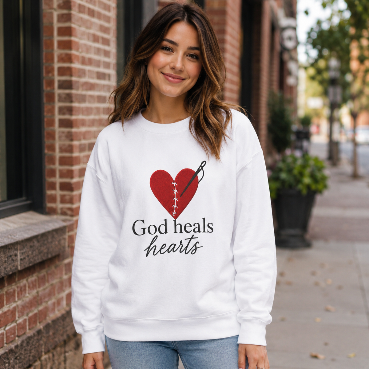 God Heals Hearts Crewneck Sweatshirt – Designed by Maxo